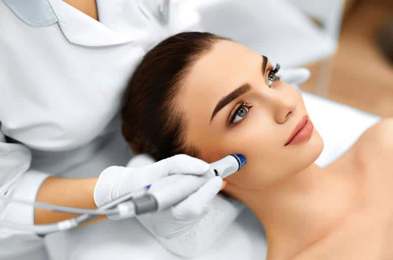 Rejuvenating skin treatment with a professional dermatologist performing a facial procedure for glowing, healthy skin at Shrinika Derma Care clinic.
